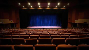 Wide angle view of an empty auditorium showing the stage and rows of seats ready for an event photo