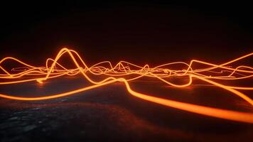 Abstract orange light trails illuminated on a dark reflective surface representing energy photo