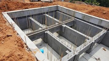 Construction site showing concrete foundation structure with reinforcement bars prepared for building a new structure photo