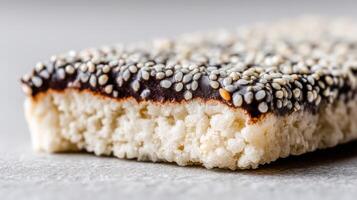 Close-up of a delicious sesame bar with chocolate coating and crispy texture on a neutral background for healthy snacks photo