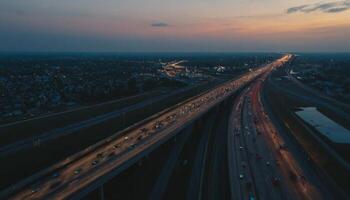 Aerial View of Busy Highway with Traffic Flowing Under Twilight Sky at Sunset photo