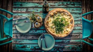 Delicious round pizza with fresh toppings served on rustic wooden table in outdoor dining setting with green chairs photo