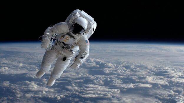 Astronaut in Space Suit Floating Above Earth with a Background of Clouds and Dark Sky photo