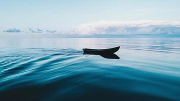A boat floating in the ocean with a cloudy sky photo