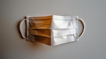 A white surgical mask on a gray background. photo