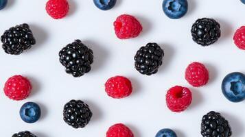 A variety of berries are arranged on a white surface photo