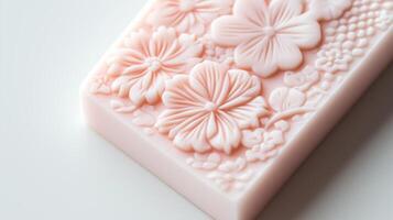 A pink soap bar with flowers on it photo