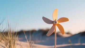 A windmill on a beach with sand dunes in the background photo
