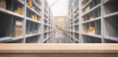 Empty wooden table mockup with blurred warehouse shelving background, ideal for product display or design presentation photo