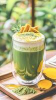 Refreshing matcha and mango multi layered beverage in a glass with nature backdrop photo