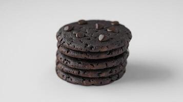 Stack of chocolate cookies with chocolate chips on white background photo