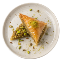 Top view of Middle Eastern Baklava, A triangle-shaped baklava piece with visible layers of phyllo pastry, crushed pistachios, and a honey-glazed finish png