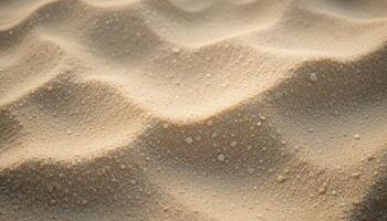 a close up of sand with water droplets on it photo