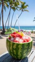 cocktail. Refreshing watermelon cocktail in a carved watermelon shell, decorated with tropical elements - pineapple slices photo
