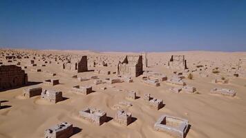 A desert with many stone buildings in the middle photo