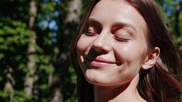 A woman is smiling while looking at the camera photo