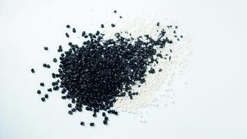 Black and white seeds on a white surface photo