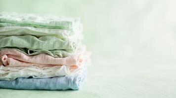 A stack of folded cloths on a green background photo