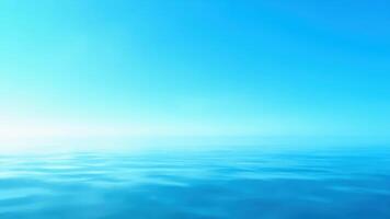A blue ocean with a bright sun in the background photo