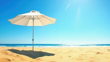 An umbrella on a sandy beach with the ocean in the background photo