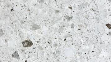 Close-up view of white terrazzo texture surface with mixed stone fragments photo