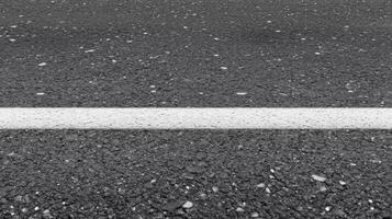 Close-up of asphalt road with white line as urban infrastructure concept photo
