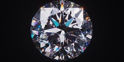 Close-up shot of a sparkling round diamond on black background capturing its brilliant cut photo