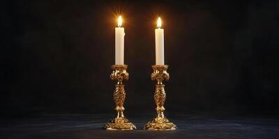 Elegant gold candle holders with lit candles illuminating a dark background photo