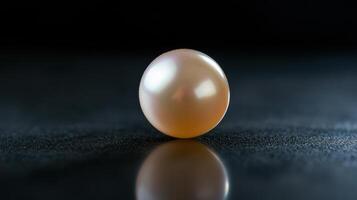 Close-up of a lustrous pearl on dark surface reflecting light highlighting elegance photo