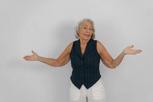 Curious Senior Woman with Her Open Hands Expressing Various Feelings of Uncertainty photo