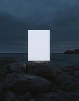 mockup of an A4 paper standing on top of rocks at night a white blank poster, minimalistic, with a very dark sky, sharp focus. photo