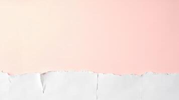 A white paper torn into pieces on a pink background photo
