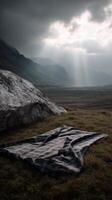 Sunbeams break through stormy clouds over mountains and plaid blanket photo
