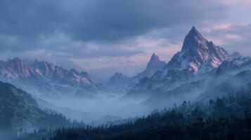 Misty mountain range at dawn with dramatic clouds and snow-covered peaks photo