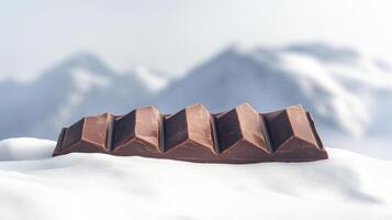 Chocolate bar on snowy mountain background with winter concept photo