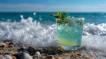 Refreshing cocktail with mint on a sunny beach surrounded by seashells photo