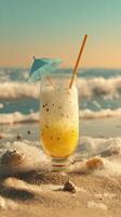 Refreshing beach cocktail with umbrella in the sand, seaside paradise photo