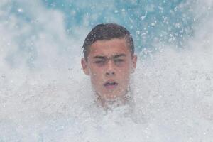 Teenage Boy's Powerful Swim Splash in Pool photo