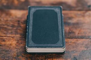 Vintage Dark Blue Book on Wooden Table Timeless Elegance photo