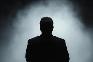 Mysterious Silhouette of a Businessman in a Dramatic Setting photo