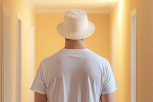 Man in a Straw Hat, Contemplating a Sunny Hallway photo