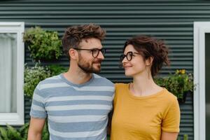 Couple Posing in Front of a Stylish Home photo