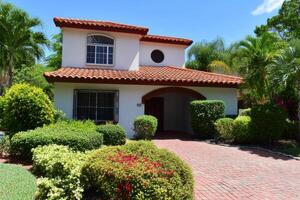 Charming Mediterranean Style House with Lush Landscaping. A Perfect Blend of Architecture and Nature. photo