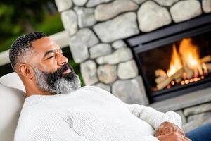 Relaxed Man by the Fireplace A Moment of Tranquility and Comfort photo
