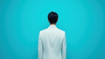 Stylish Minimalist Portrait of a Person in a White Suit against a Bold Blue Background photo