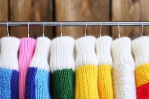 Colorful Knitted Sweaters Hanging on a Rack photo
