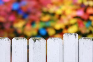 Vintage White Wooden Fence with Colorful Background photo