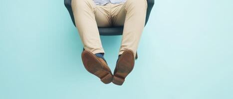 Feet on chair soft blue backdrop photo