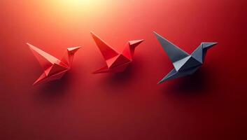 Colorful origami birds displayed on wall. Three origami birds in red and blue are artistically arranged on a wall, creating an engaging visual display. photo