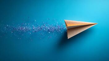 Paper plane in bright sparks. A paper airplane soars across a bright blue background, leaving a trail of colorful particles in its wake. photo